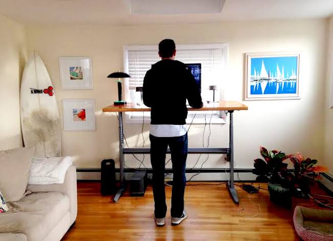 Alex Turnbull working at a standing desk in his home office